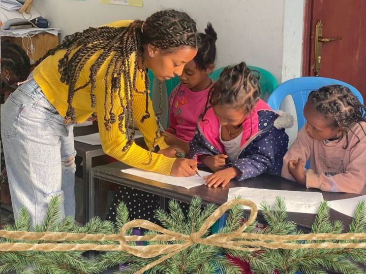 After school tutoring teacher with children in class in Korah Ethiopia