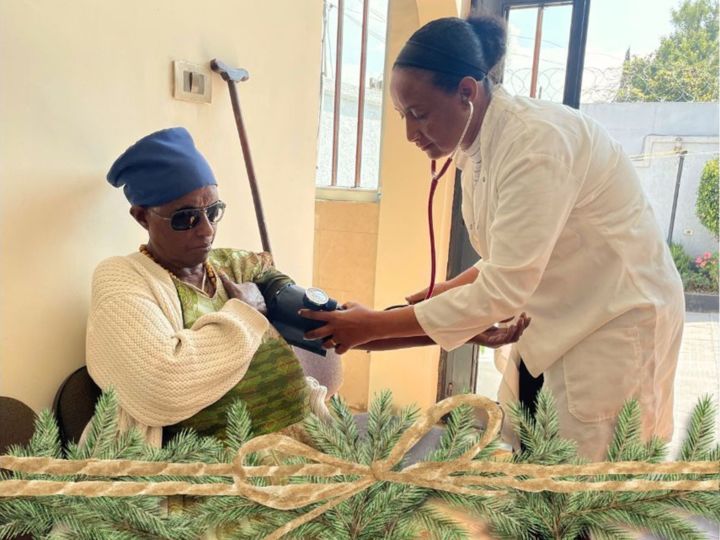 Ethiopian nurse taking blood pressure of patient in Korah Ethiopia