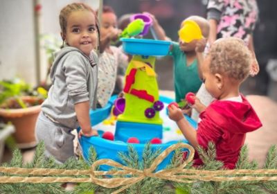 Daycare children play at water table in Korah, Ethiopia