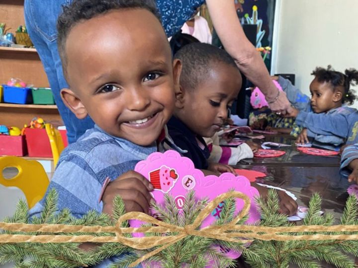 Child with heart card made at daycare in Korah Ethiopia