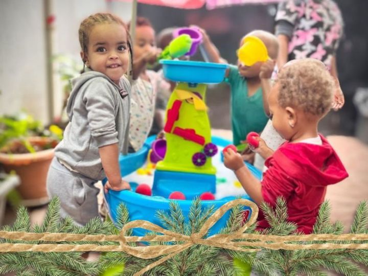 Daycare children play at water table in Korah, Ethiopia