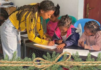 After school tutoring teacher with children in class in Korah Ethiopia