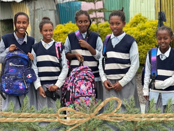 Children with new backpacks in youth compound in Korah Ethiopia