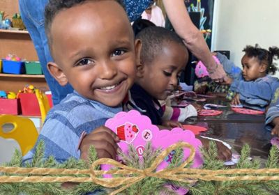 Child with heart card made at daycare in Korah Ethiopia