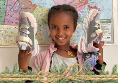 Girl holding up new shoes