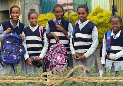 Children with new backpacks in youth compound in Korah Ethiopia