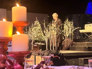 Lady speaking by candlelight at Christmas